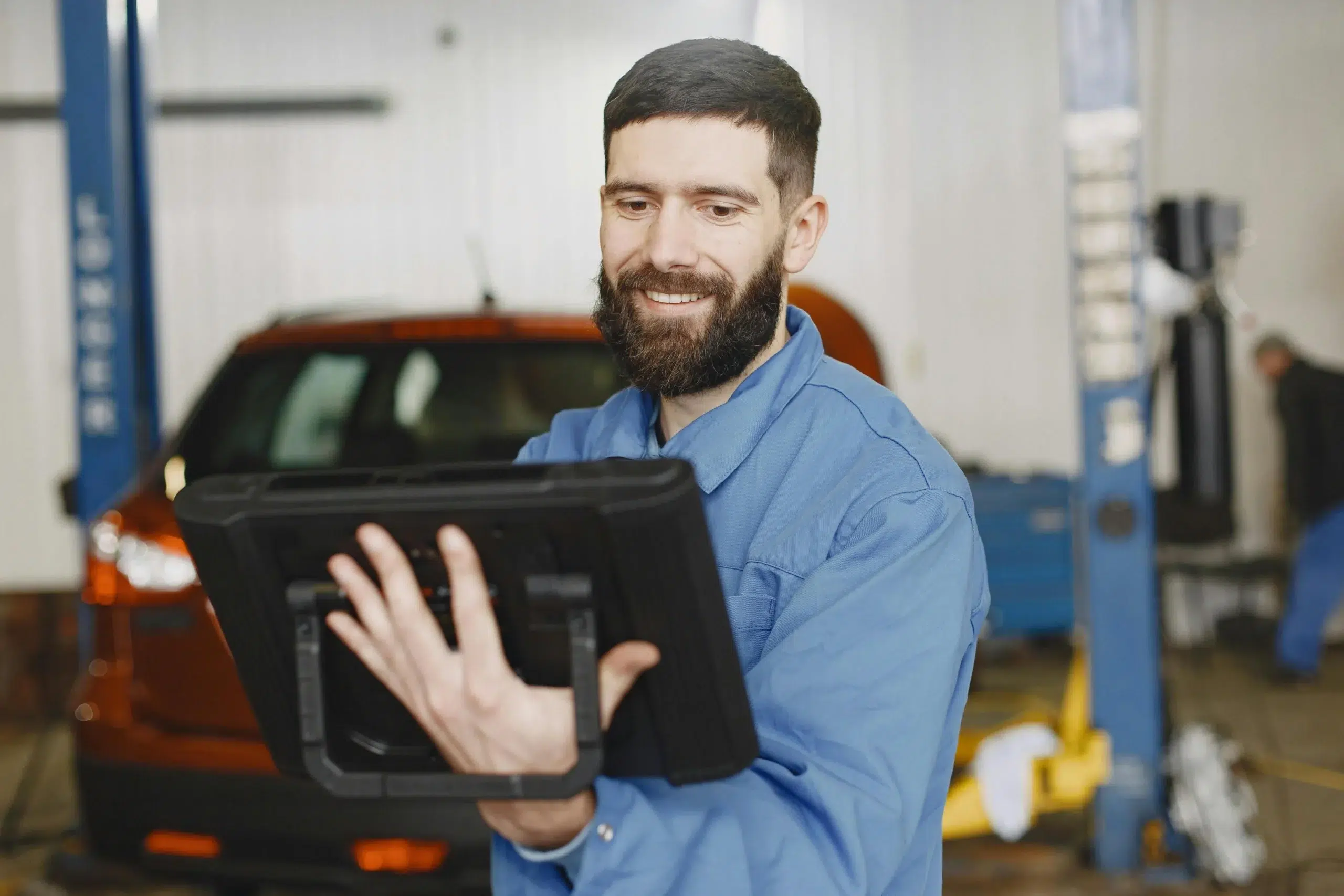 Maintenance personnel executing a digital preventive maintenance checklist on a secure mobile tablet, connected to a local enterprise CMMS server.